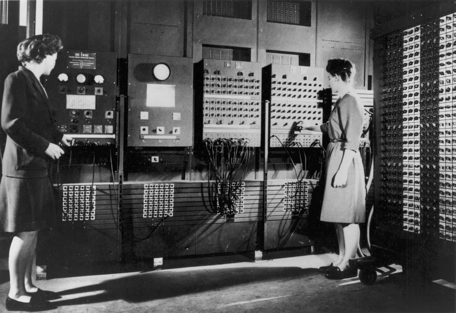 Two programmers setting up ENIAC by its plugboards, 1946